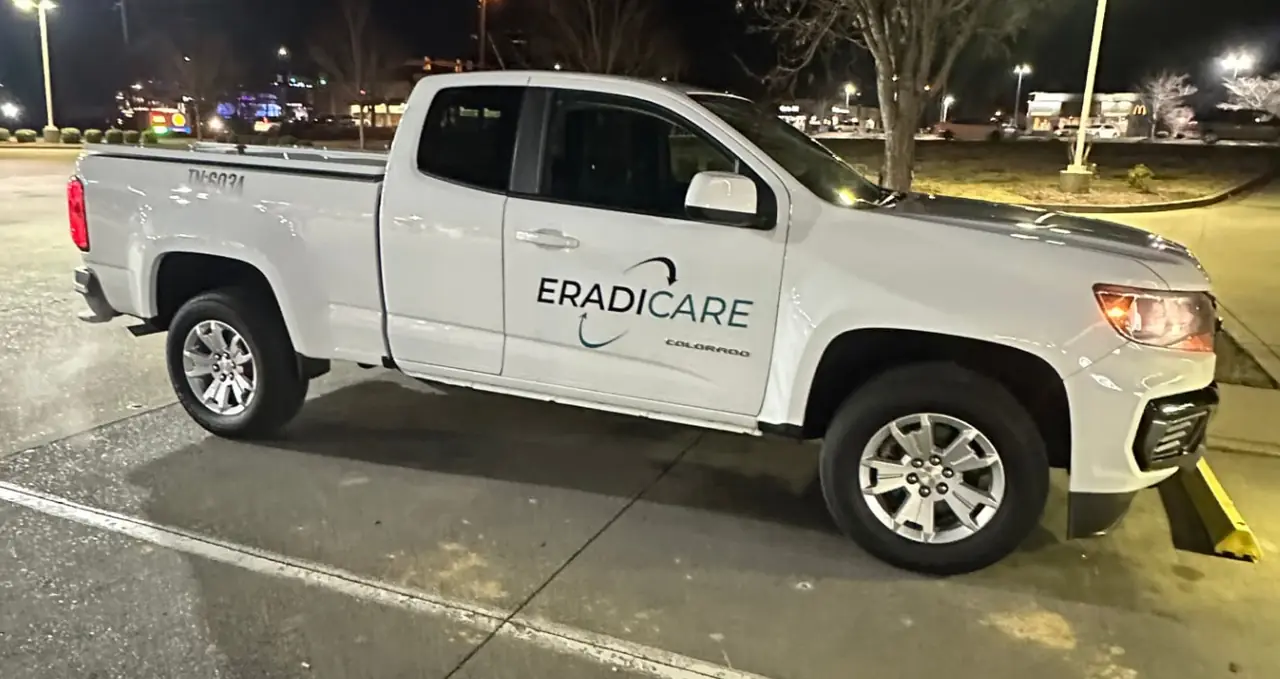 Eradicare service truck parked at a Tennessee job site at night
