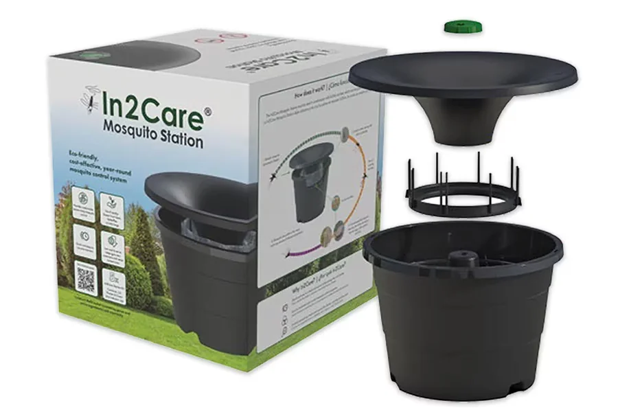 An In2Care mosquito station placed in shaded shrubbery in a backyard
